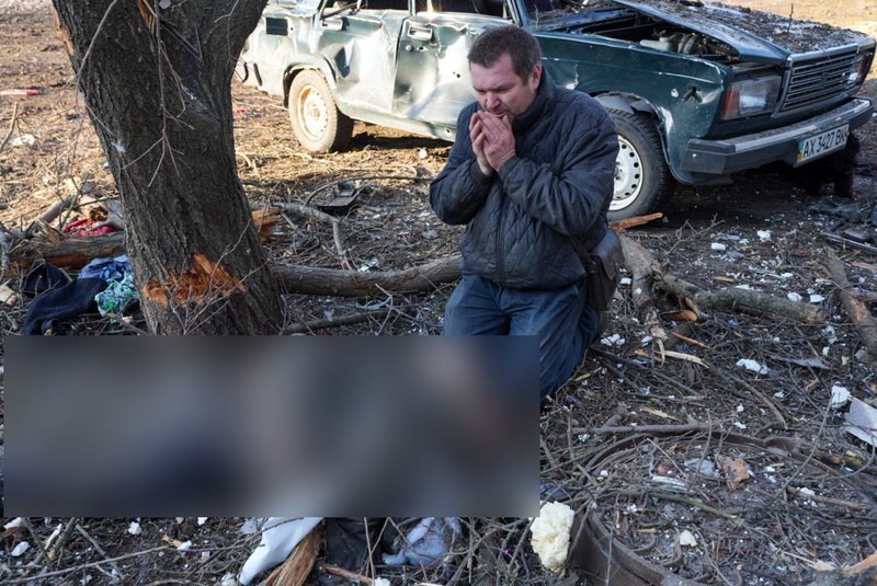 Un bărbat plânge moartea unei persoane, în fața unui un bloc lovit de bombardamentul rusesc în Ciuhuiiv, lângă orașul Harkov FOTO: Hepta