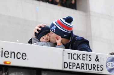 epa04603733 The Super Bowl XLIX Champion New England Patriots Quarterback Tom Brady kisses his son as the Patriots parade on Duck Boats on Boylston Street in Boston, Massachusetts, USA, 04 February 2015. The New England Patriots beat the Seattle Seahawks in Super Bowl XLIX on 01 February. EPA/NEAL HAMBERG