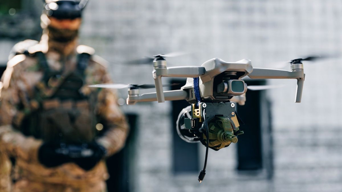 Operator de dronă soldat lansează o dronă militară cu o bombă pentru a o arunca în fortificațiile și tranșeele inamice. Concept de utilizare a roboților militari în războiul modern