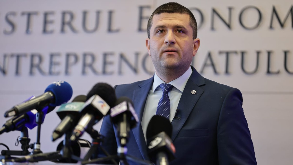 Radu Miruță într-un-costum albastru închis, o cravată albastră și o cămașă albastru deschis