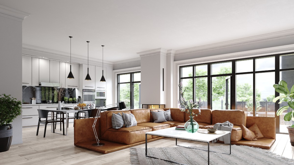 Living open space combinat cu bucatarie, spatios si modern. In fata este o masuta de cafea cu piciare subtiri pe care se afla o vaza cu flori si este pusa pe un covor crem cu ciucuri la capete. In spatele masutei este un divan mare, caramiziu, iar in spate se afla o masa si mobila de bucatarie