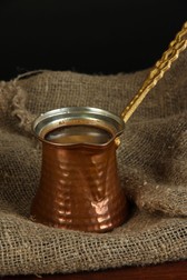 23681665 - metal turk and coffee beans on dark background