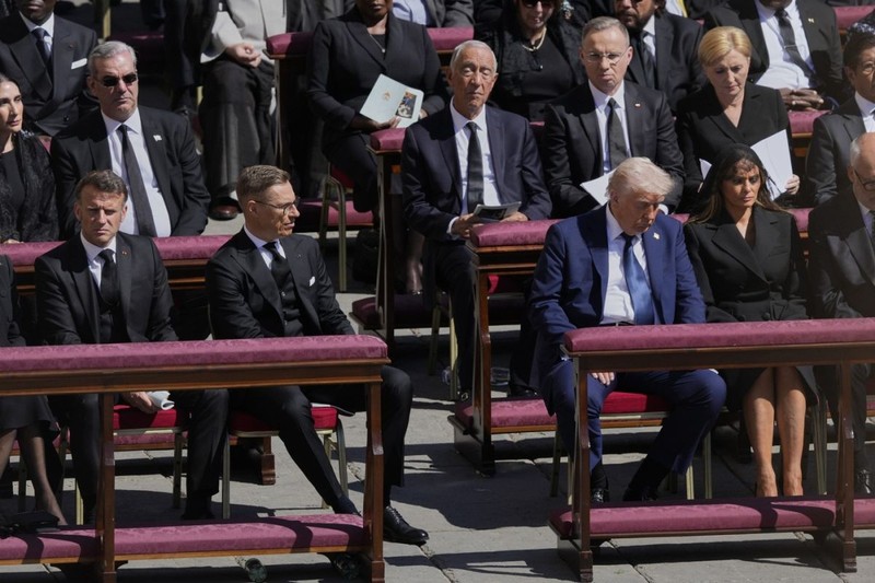 President Donald Trump, third from right, flanked by first lady Melania Trump, French President Emmanuel Macron, front row left, and Finland's President Alexander Stubb, second left, attend the funeral of Pope Francis in St. Peter's Square at the Vatican, Saturday, April 26, 2025. (AP Photo/Gregorio Borgia)