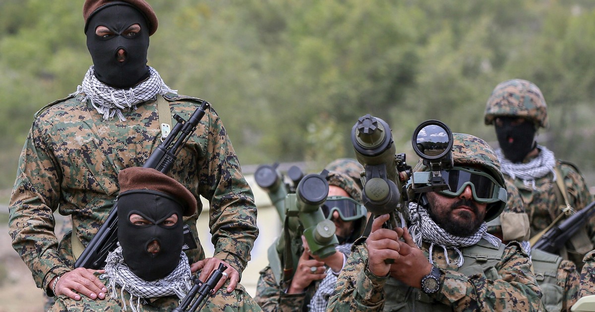 Luptători Hezbollah înarmați într-o tabără din Liban.