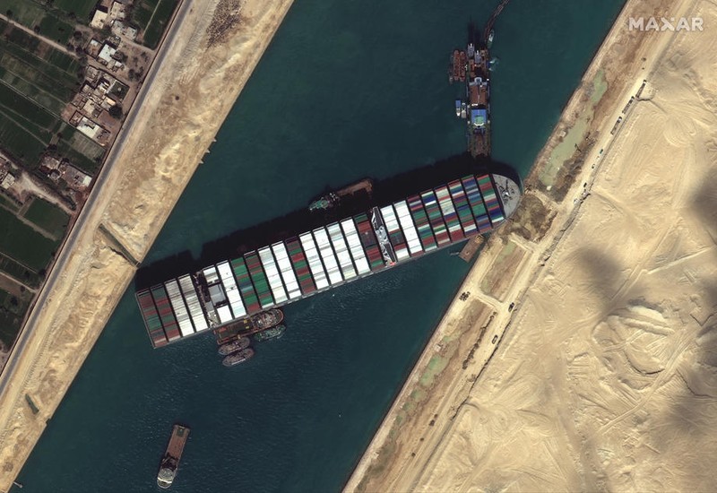 epa09101181 A handout satellite image made available by MAXAR Technologies shows multiple tug boats positioned alongside the 'Ever Given' and dredging operations in progress, in the Suez Canal, Egypt, 27 March 2021. The large container ship Ever Given ran aground in the Suez Canal on 23 March, blocking passage of other ships and causing a traffic jam for cargo vessels. The head of the Suez Canal Authority announced on 25 March that 'the navigation through the Suez Canal is temporarily suspended' until the floatation of the Ever Given is completed. Its floatation is being carried out by eight large tugboats that are towing and pushing the grounding vessel. EPA-EFE/MAXAR TECHNOLOGIES HANDOUT -- MANDATORY CREDIT: SATELLITE IMAGE 2020 MAXAR TECHNOLOGIES -- the watermark may not be removed/cropped -- HANDOUT EDITORIAL USE ONLY/NO SALES HANDOUT EDITORIAL USE ONLY/NO SALES