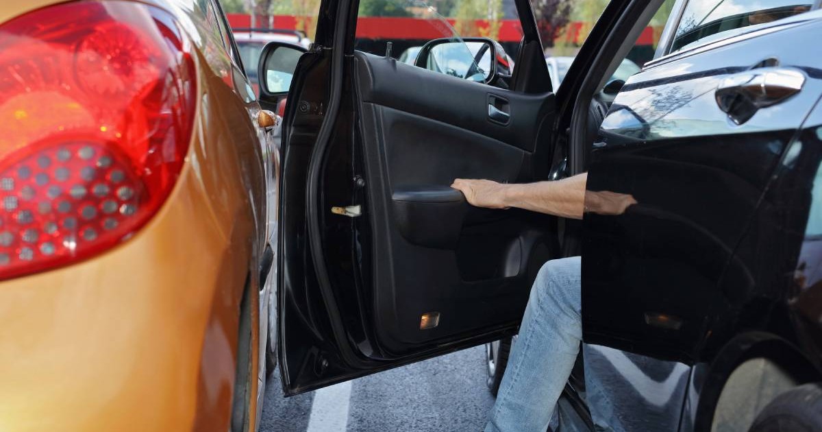 doua masini parcate una langa alta, din masina din dreapta iese un sofer, iar portiera se apropie mult de masina de langa
