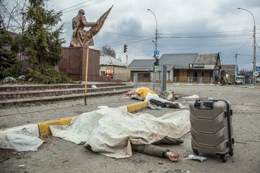 Două cadavre zac pe o stradă din Irpin, 6 martie 2022. Oamenii, toți membri ai aceleiași familii, au murit în timp ce încercau să plece din Irpin, oraș aflat în apropiere de Kiev și supus unor bombardamente. Imaginea explicită cu trupurile lor neînsuflețite a fost publicată pe prima pagină a ziarului The New York Times. Ulterior, un ucrainean și-a recunoscut familia în poză: erau soția și copiii lui, care au rămas lângă Kiev, în timp ce el a mers în Donețkul aflat sub ocupație, pentru a-și îngriji mama bolnavă, crezând că familia sa va fi în siguranță lângă capitala ucraineană