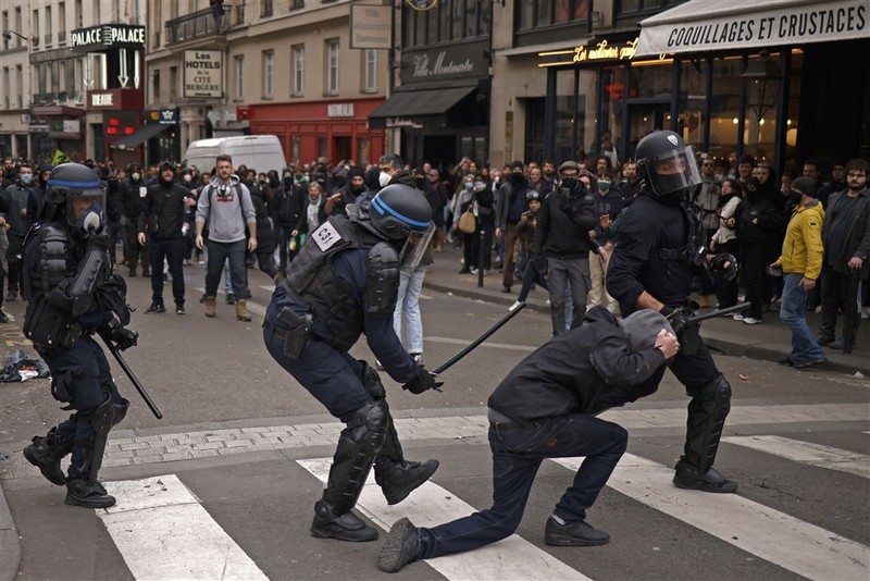 epa10538913 French police officers arrest a protester during clashes as thousands of people participate in a protest against the government's reform of the pension system in Paris, France, 23 March 2023. Protests continue in France after the prime minister announced on 16 March 2023 the use of Article 49 paragraph 3 (49.3) of the French Constitution to have the text on the controversial pension reform law - raising retirement age from 62 to 64 - be definitively adopted without a vote. EPA-EFE/YOAN VALAT