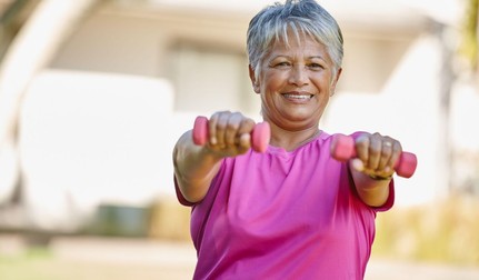 Parc, gantere și portretul unei femei în vârstă pentru antrenament, wellness și exerciții în aer liber. Persoană pensionară, fericită și matură, cu greutăți în natură
