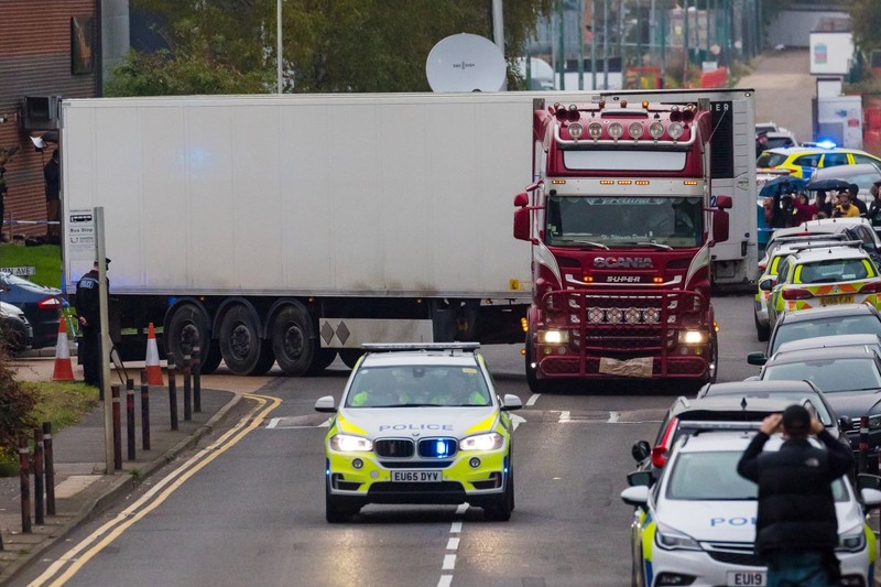 epaselect epa07943573 Police drive the lorry container along the road from the scene in Waterglade Industrial Park in Grays, Essex, Britain, 23 October 2019. A total of 39 bodies were discovered inside a lorry container in the early hours of this morning, and pronounced dead at the scene. EPA-EFE/VICKIE FLORES