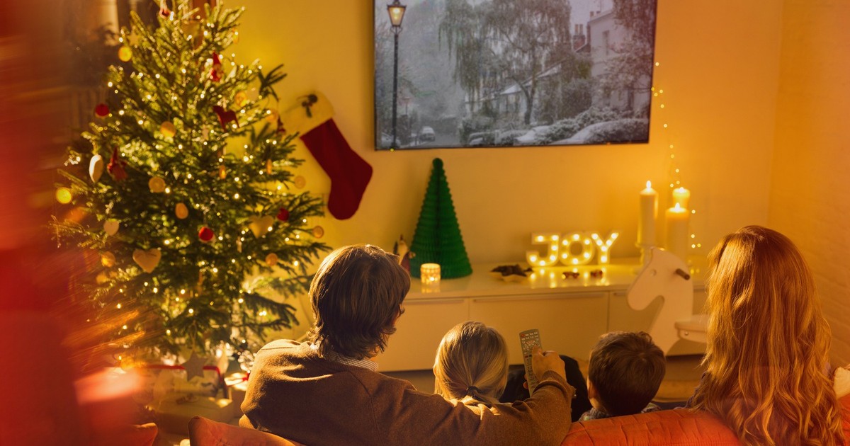 Imagine cu o familie care se uită la televizor