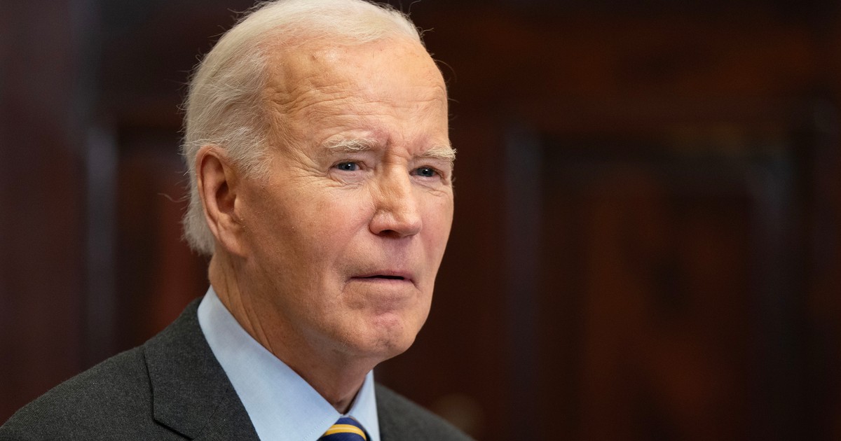 Foto cu Joe Biden purtând o cămașă albastră, cu un sacou negru