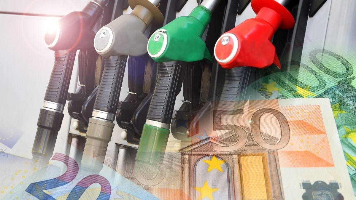 Imagine creativă cu pompe de benzină și motorină de culoare roșu, verde și negru, iar în partea de jos a fotografiei, bancnote de 20 și 50 de euro în blur