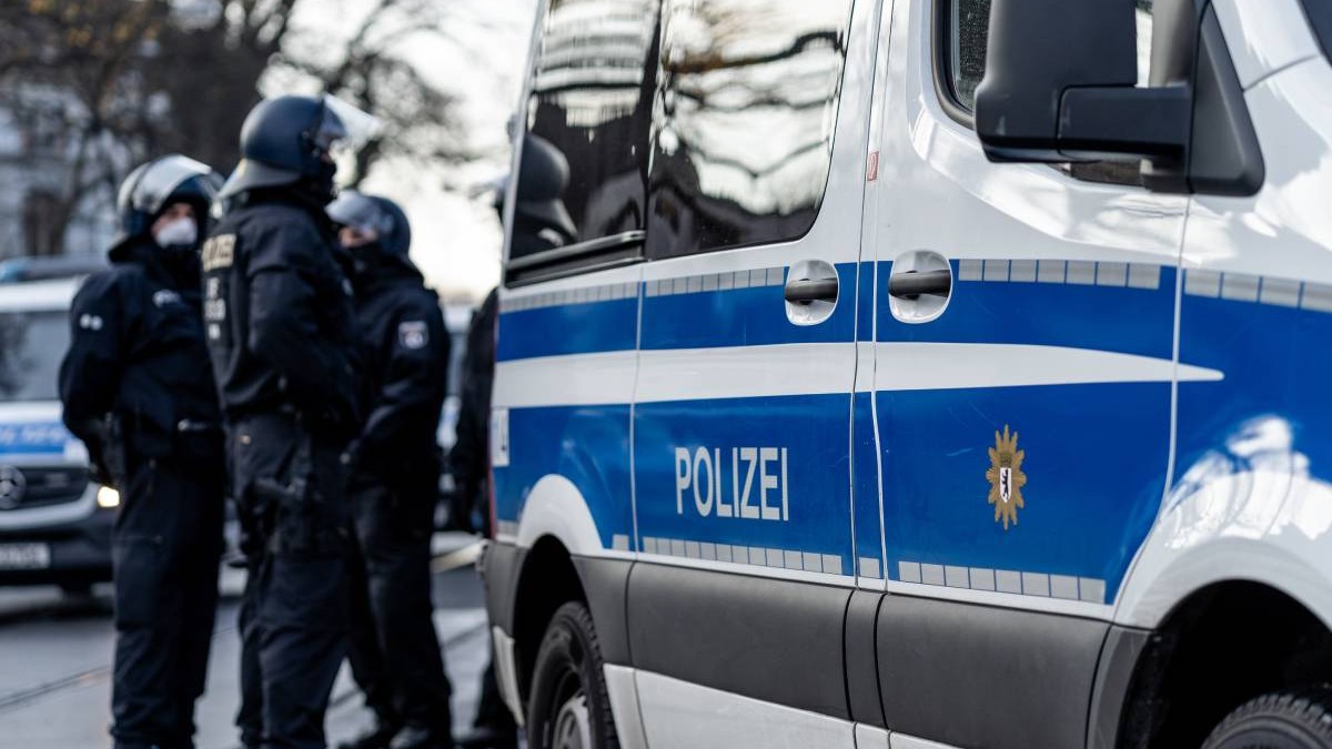 Mai multi politisti in Germania, langa o masina de politie, iarna