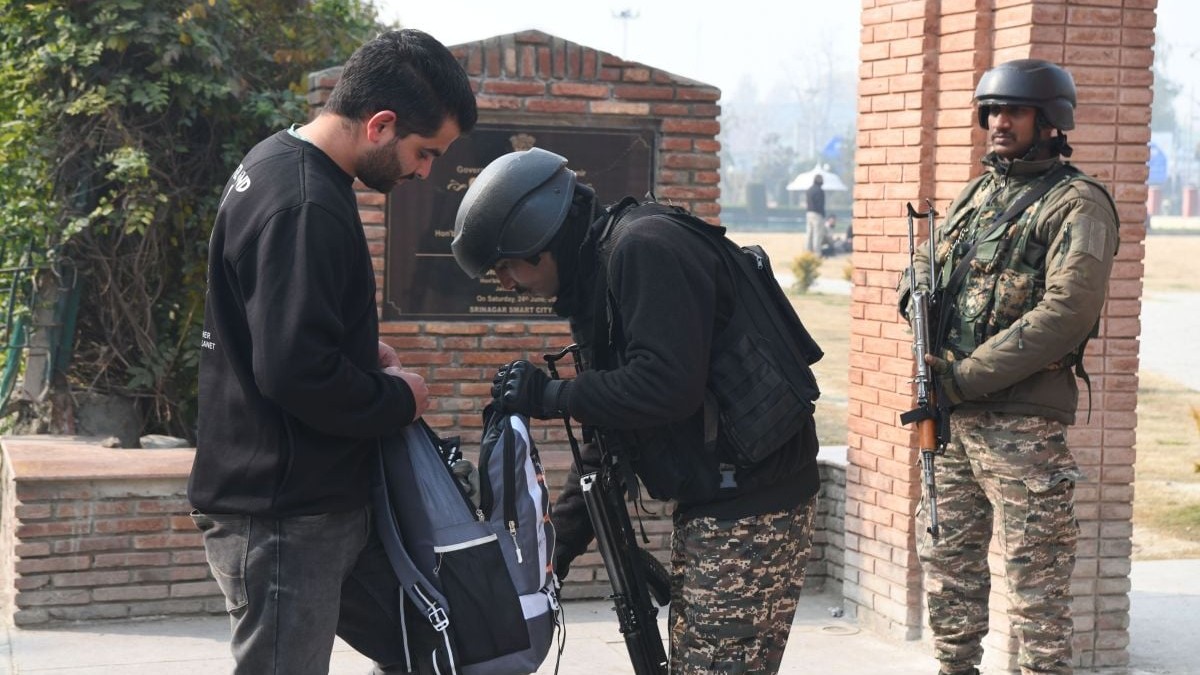 Un polițist indian verifică geanta unui pieton în Srinagar, 18 noiembrie 2025