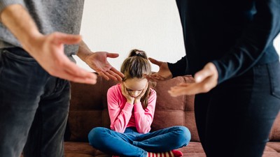 stressed little girl upset tired of parents fight.