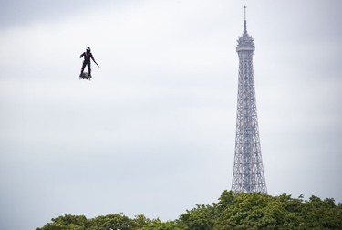 epaselect epa07716014 Professional pilot Franky Zapata demonstrates a flight on a 'flyboard', which the French army is considering using for military purposes, during the annual Bastille Day military parade on the Champs Elysees avenue in Paris, France, 14 July 2019. Bastille Day, the French National Day, is held annually on 14 July to commemorate the storming of the Bastille fortress in 1789. EPA-EFE/IAN LANGSDON