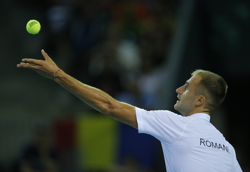 epa05426041 Romania's Marius Copil in action against Spain's Feliciano Lopez during their match for the Davis Cup group I tie between Romania and Spain at Polivalenta Soprts Hall in Cluj city, western Romania, 15 July 2016. EPA/ROBERT GHEMENT