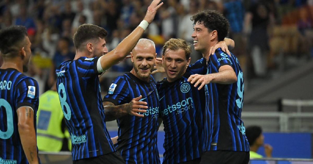 Jucătorii lui Inter Milano sărbătoresc împreună un gol pe stadion, îmbrăcați în echipamentul lor albastru-negru.