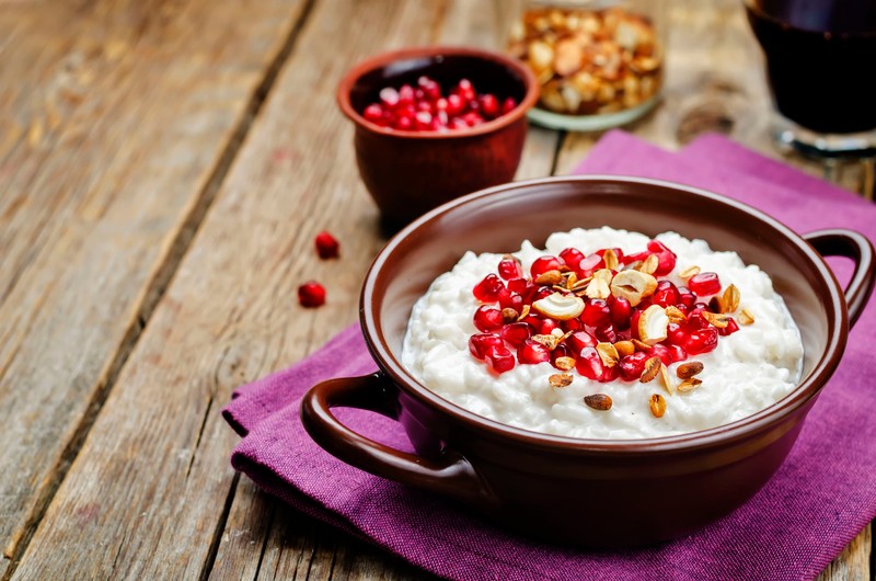 66029150 - coconut rice with pomegranate and granola. toning. selective focus