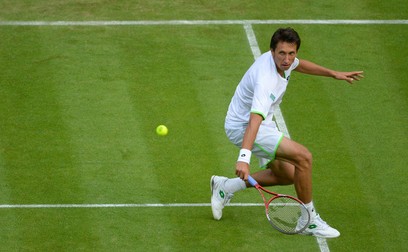 LONDON, ENGLAND - JUNE 26: Sergiy Stakhovsky of Ukraine plays a backhand during his Gentlemen's Singles second round match against Roger Federer of Switzerland on day three of the Wimbledon Lawn Tennis Championships at the All England Lawn Tennis and Croquet Club on June 26, 2013 in London, England. (Photo by Mike Hewitt/Getty Images)