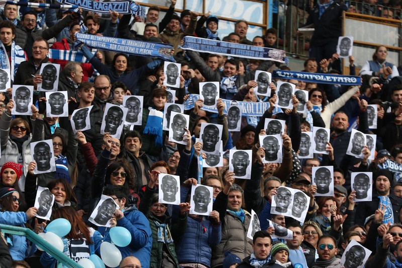 epa05147805 Napoli's supporters show photos of Napoli's player Kalidou Koulibaly, in solidarity after the player was racially abused by Lazio fans in their previous game, prior to the Italian Serie A soccer match against Carpi FC at San Paolo stadium in Naples, Italy, 07 February 2016. EPA/CESARE ABBATE
