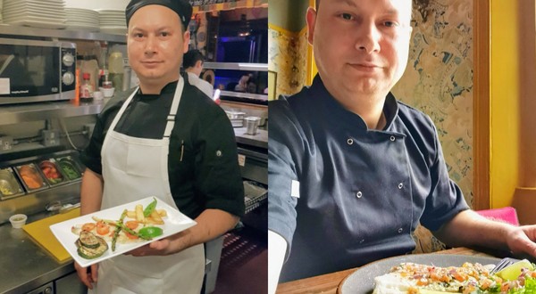 Un bărcat îmbrăcat în uniformă neagră de chef, poartă un șorț alb și este în bucătăria unui restaurant