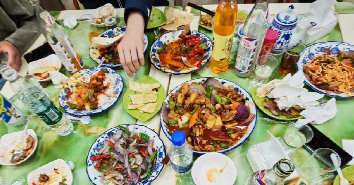 O masă plină cu farfurii cu mâncare, într-un restaurant din China