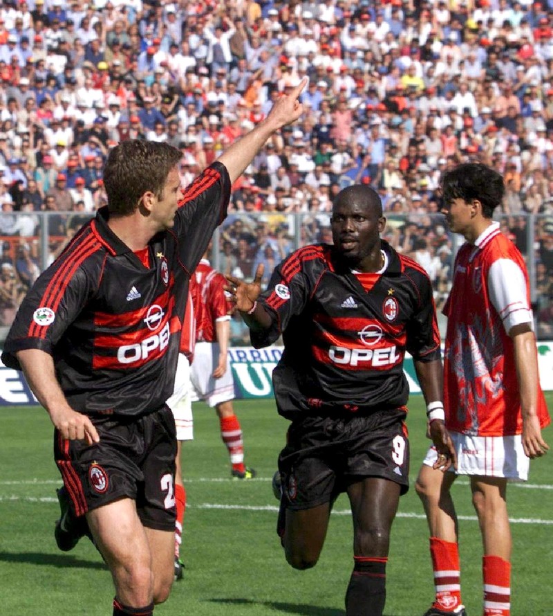 I10-19990523-PERUGIA, ITALY: German striker Oliver Bierhoff (left) of AC Milan celebrates with team-mate Georges Weah, after he scored the 2-0 lead for his site, his 20th goal of the season, during their Italian Serie A clash in Perugia, Sunday 23 May 1999. AC Milan defeated Perugia 2-1 and grabbed the national league title, one point ahead of second placed Lazio Rome. It is the 16th title win for the Italian giant. EPA PHOTO/ANSA/MAURIZIO BRAMBATTI