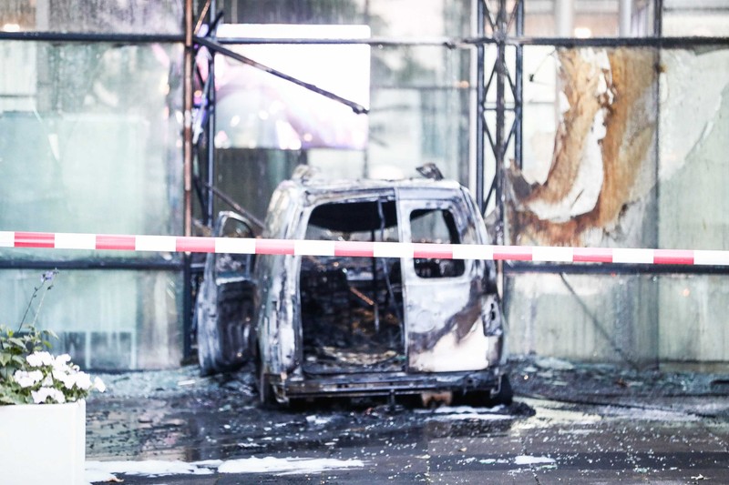 epa06840494 A view of a van that crashed through the front door of the building that houses newspaper De Telegraaf on Basisweg in Amsterdam, The Netherlands, 26 June 2018. The vehicle went up in flames, causing a large amount of damage to the building. No one was injured in the accident. EPA-EFE/KOEN VAN WEEL
