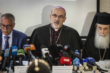 FILED - 16 May 2022, ---, Jerusalem: Pierbattista Pizzaballa (C), the Latin Patriarch of Jerusalem, delivers a condemning statement at Saint Joseph Hospital in the aftermath of the Israeli police actions on Friday during the funeral of of slain reporter Shireen Abu Akleh. Patriarch Pierbattista Pizzaballa, the highest-ranking Catholic dignitary in the Holy Land, has made a pre-Christmas visit to the embattled Gaza Strip. Photo: Ilia Yefimovich/dpa