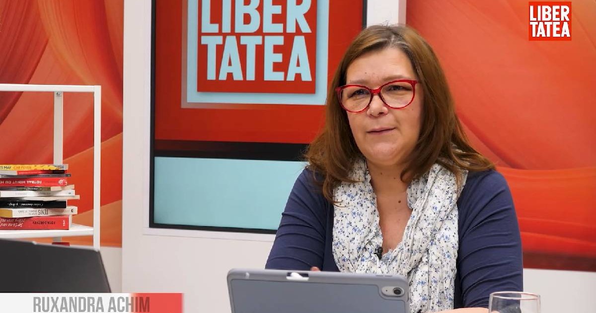 profesoara Ruxandra Achim care sta in fata unui laptop la birou