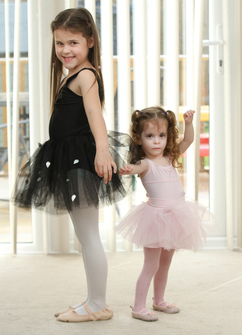 *** UK OUT *** *** EXCLUSIVE *** SANDHURST, UNITED KINGDOM - UNDATED: Three year old Rebecca Lewendon with sister Kimberley (7) pictured at home in Sandhurst, Berkshire, England. STANDING at only 80 centimetres tall, tiny Rebecca Lewendon could be forgiven for taking a back seat. But the pint sized Thumbelina is determined that her tiny stature wont set her back. Her parents were baffled when she failed to grow when she was born. But she has been diagnosed with a rare growth condition that means at the age of three, she is still only the height of a 12 month old baby. But she is determined to live a normal life - and to join in ballet classes with her sister Kimberley, seven, and brother Ryan, five. PHOTOGRAPH BY Worldwide Features / Barcroft Media UK Office, London. T +44 845 370 2233 W www.barcroftmedia.com USA Office, New York City. T +1 212 796 2458 W www.barcroftusa.com Indian Office, Delhi. T +91 11 4053 2429 W www.barcroftindia.com *** Local Caption *** 02455796