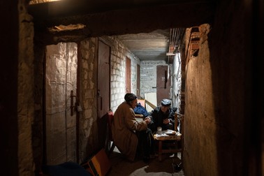 Un cuplu în vârstă bea ceai în subsolul casei lor din Lyman, regiunea Donețk, estul Ucrainei, sâmbătă, 30 aprilie 2022. Foto: Profimedia