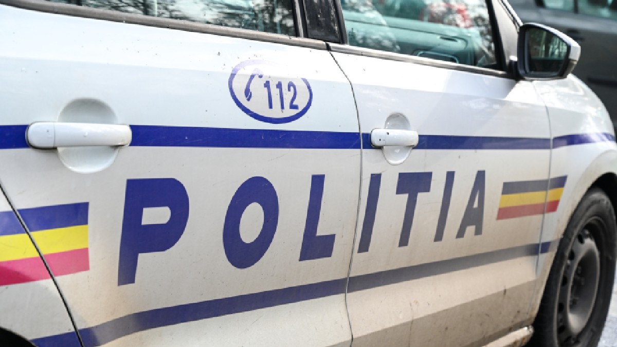 Vedere laterală a unei mașini de poliție cu inscripția „Poliția”.
