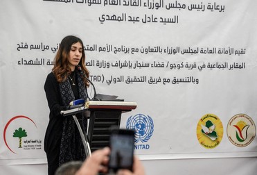 Iraqi Yazidi and Nobel Peace Laureate Nadia Mourad speaks during the exhumation of a mass-grave of hundreds of Yazidis killed by Islamic State (IS) group militants in the northern Iraqi village of Kojo in Sinjar district on March 15, 2019. Iraqi authorities exhumed the mass grave in an operation aiming to extract remains and identify victims of an August 2014 massacre of Yazidis by IS fighters as they entered the village of Kojo, during investigations of genocide against the decimated minority.,Image: 419910738, License: Rights-managed, Restrictions: , Model Release: no