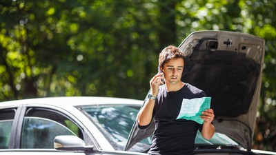 Handsome,Young,Man,Calling,For,Assistance,With,His,Car,Broken
