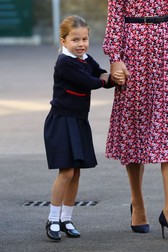 Princess Charlotte holds the hand of her mother, the Duchess of Cambridge, as she arrives for her first day of school at Thomas's Battersea in London.