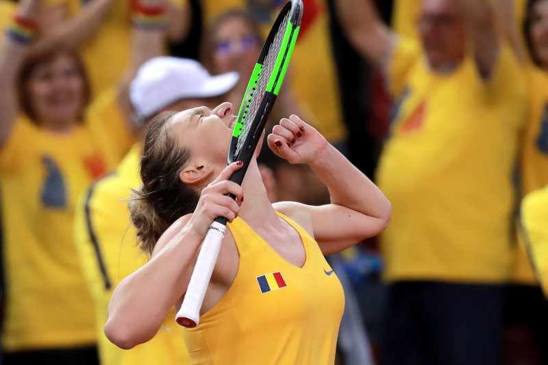 epa07517689  Simona Halep of Romania celebrates after winning her game against Kristina Mladenovic of France during the Fed Cup World Group, Semi Final between France and Romania, in Rouen, France, 20 April 2019 EPA-EFE/CHRISTOPHE PETIT TESSON