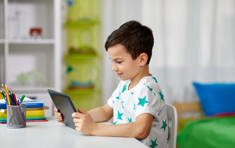 education, people and learning concept - happy student boy with tablet pc computer and notebook learning at home