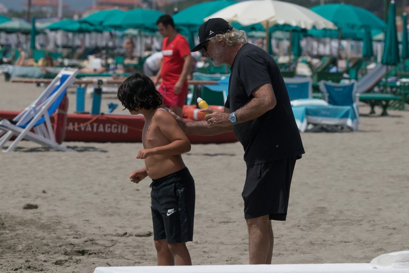 Flavio Briatore enjoying a day on the beach with son Nathan Falco ; he's seen smoking a narghile and chatting with friend Daniela Santanchè. 02 Jun 2018 Pictured: Flavio Briatore, Nathan Falco Briatore. Photo credit: MEGA TheMegaAgency.com +1 888 505 6342 June 2, 2018 *** Local Caption *** MEGA232839_004