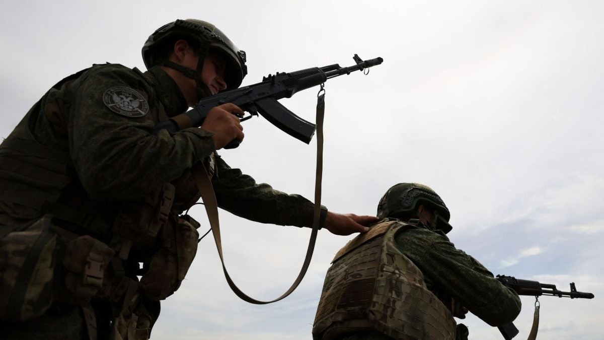 Doi militari ruși se antrenează pe un teren din apropierea frontului din Donbas, mai 2025