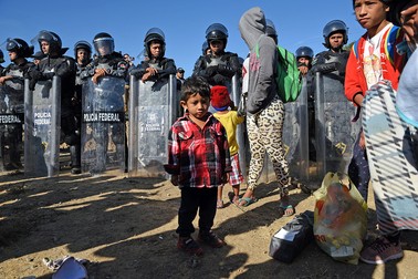 Migranți așteaptă să treacă granița dintre Mexic și Stalele Unite între Tijuanaspre și San Diego. Foto Northfoto