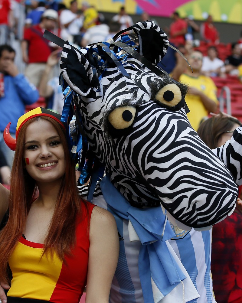 epa04300584 An Argentinian (R) and a Belgian supporter before the FIFA World Cup 2014 quarter final match between Argentina and Belgium at the Estadio Nacional in Brasilia, Brazil, 05 July 2014. (RESTRICTIONS APPLY: Editorial Use Only, not used in association with any commercial entity - Images must not be used in any form of alert service or push service of any kind including via mobile alert services, downloads to mobile devices or MMS messaging - Images must appear as still images and must not emulate match action video footage - No alteration is made to, and no text or image is superimposed over, any published image which: (a) intentionally obscures or removes a sponsor identification image; or (b) adds or overlays the commercial identification of any third party which is not officially associated with the FIFA World Cup) EPA/DENNIS SABANGAN EDITORIAL USE ONLY